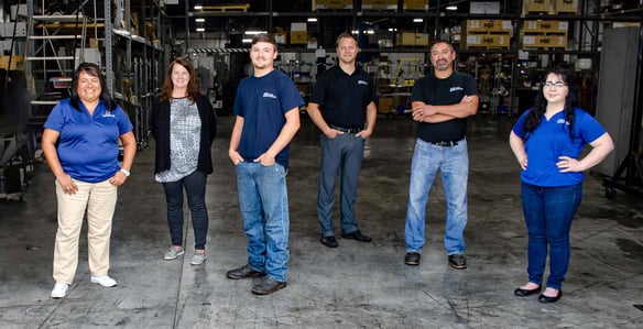 Wauseon Machine team members pose outside of plant